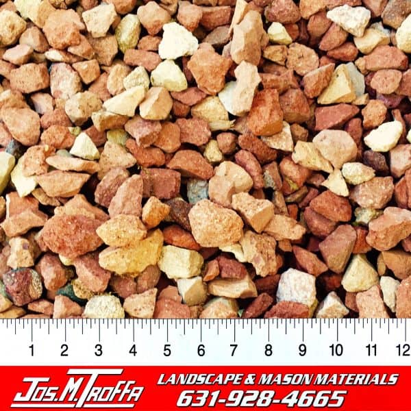 Mixed red, brown, and beige gravel stones shown with a ruler for scale, from JOS. M. TROFFA Landscape & Mason Materials in Long Island, NY.