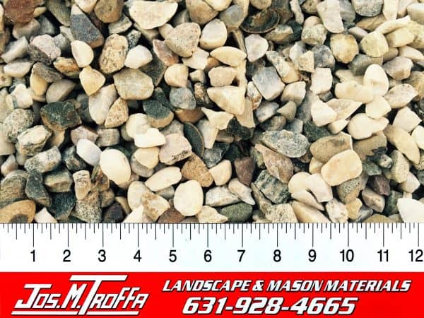 Small gray gravel stones shown with a ruler for scale, from JOS. M. TROFFA Landscape & Mason Materials in Long Island, NY.