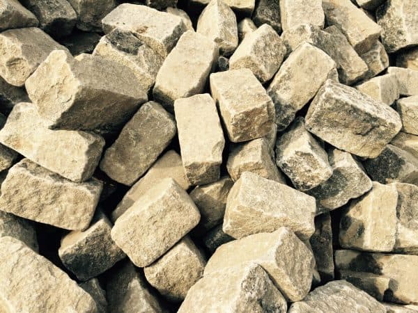 Pile of roughly cut rectangular stones, likely limestone or sandstone, used for construction or landscaping in Long Island, NY.